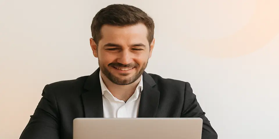Professional using a laptop to analyze outsourcing efficiency reports