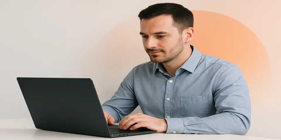 Professional using a laptop to monitor IT performance data.